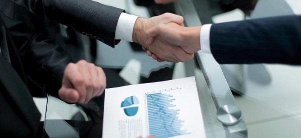 close up investor and businessman shaking hands